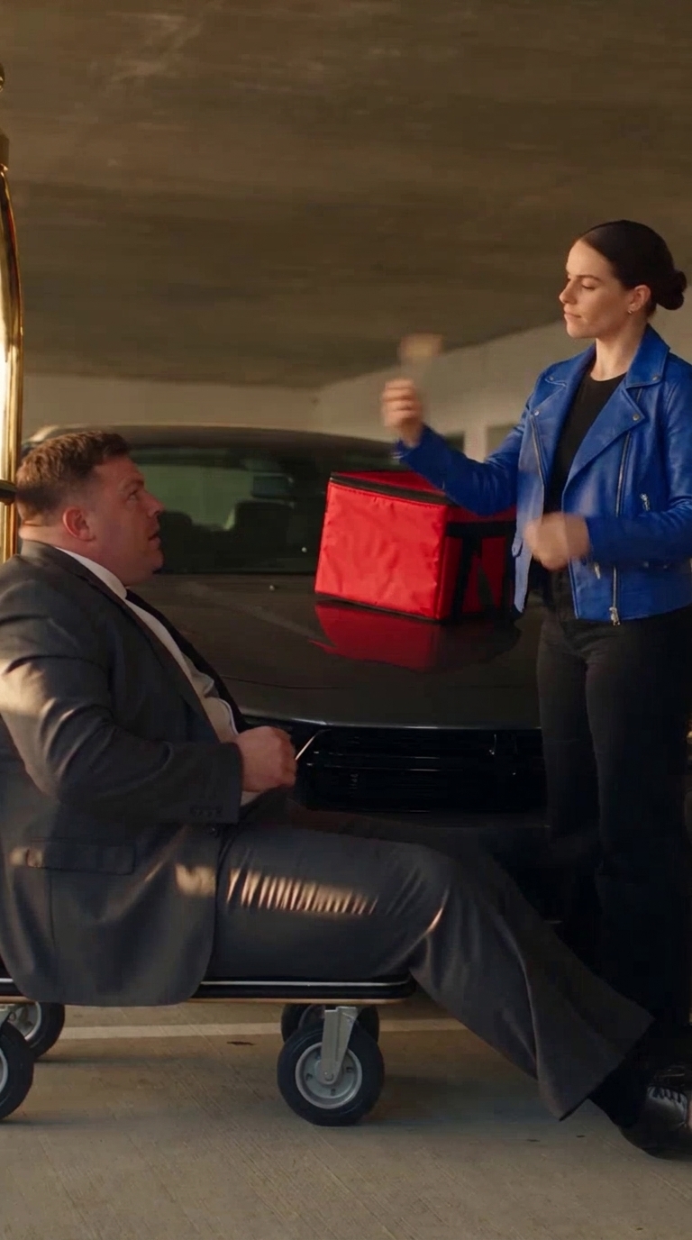 Actual Nano Banana PRO reference showing the courier in a cobalt-blue jacket beside her red delivery bag